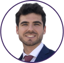 Headshot of a young man with dark hair and beard, wearing a dark suit, white shirt, and red tie, smiling at the camera against a white background—perfect for a professional Cybericon2024 profile.